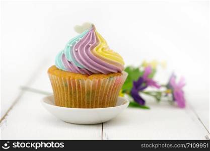 Cupcakes are beautifully decorated in clear lighting, AF point selection.