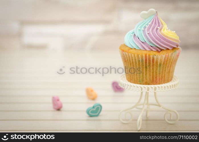 Cupcakes are beautifully decorated in clear lighting, AF point selection.