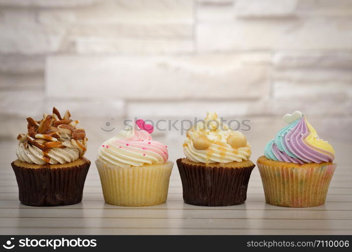 Cupcakes are beautifully decorated in clear lighting, AF point selection.