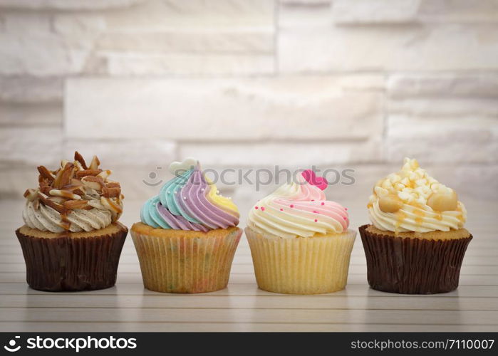 Cupcakes are beautifully decorated in clear lighting, AF point selection.