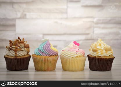 Cupcakes are beautifully decorated in clear lighting, AF point selection.