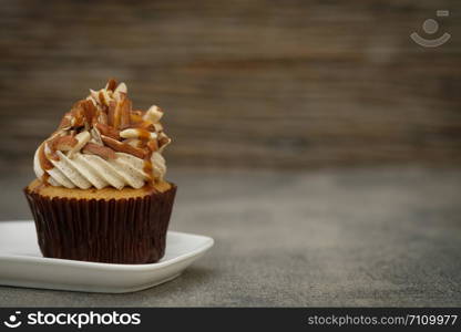 Cupcakes are beautifully decorated in Dark lighting, AF point selection.