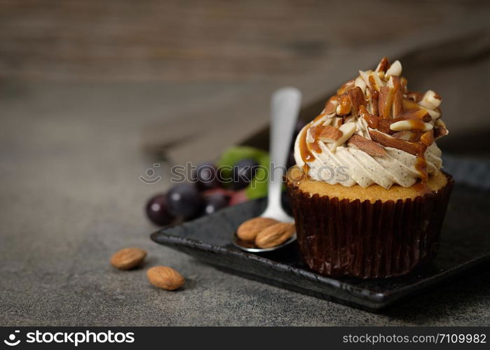 Cupcakes are beautifully decorated in Dark lighting, AF point selection.