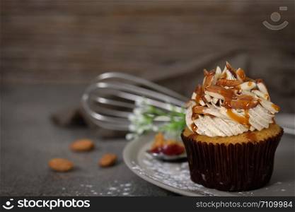 Cupcakes are beautifully decorated in Dark lighting, AF point selection.