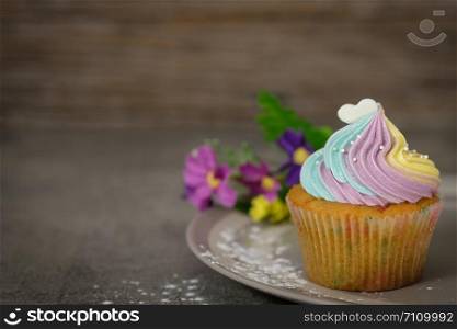 Cupcakes are beautifully decorated in Dark lighting, AF point selection.