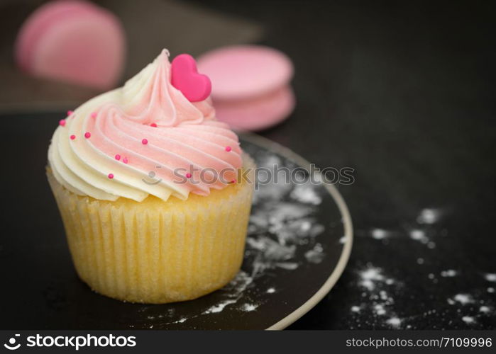 Cupcakes are beautifully decorated in Dark lighting, AF point selection.