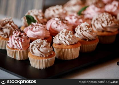 Cupcakes with curls of creamy strawberry glaze.. Cupcakes with curls of creamy strawberry glaze