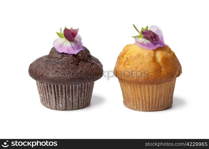 Cupcakes with fresh Sweet pea flowers on white background