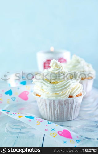 cupcuke with white cream on a table