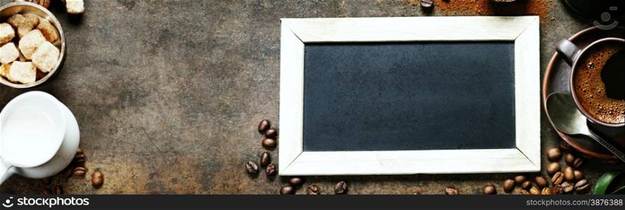 Cupof coffee and chalk board menu on dark vintage background