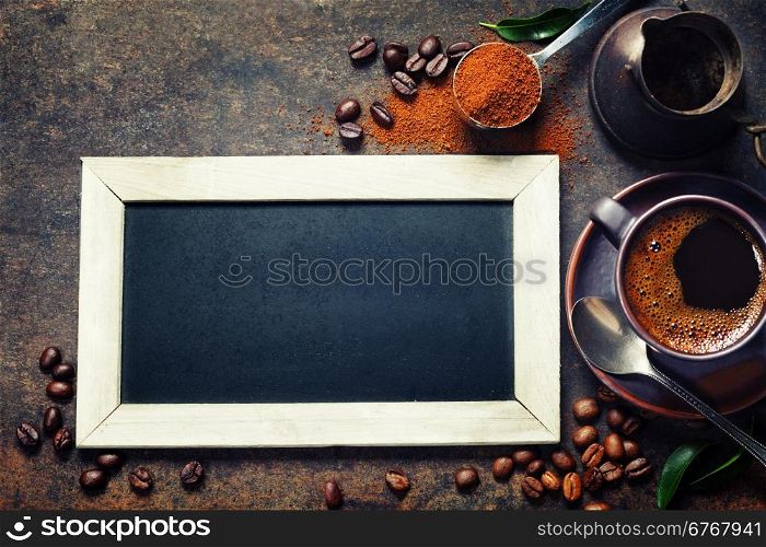 Cupof coffee and chalk board menu on dark vintage background