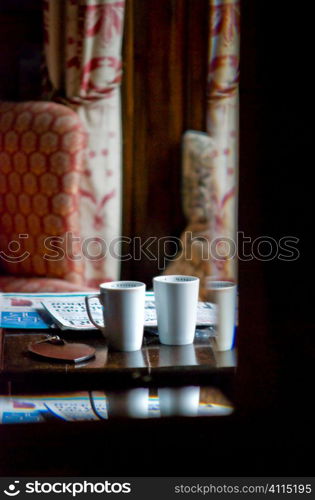 Cups and newspapers in hotel foyer