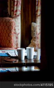 Cups and newspapers in hotel foyer