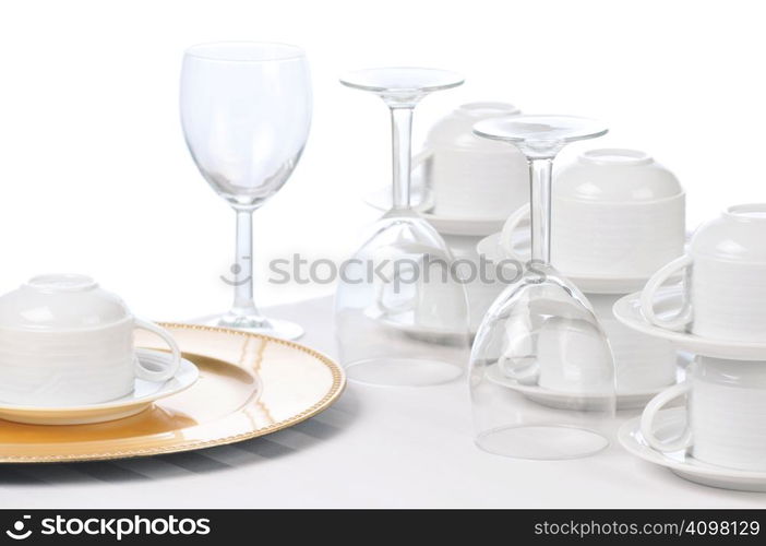 Cups and Wine Glasses on Restaurant Table isolated over white