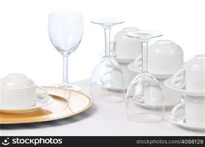 Cups and Wine Glasses on Restaurant Table isolated over white