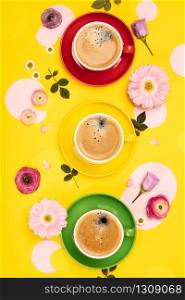 Cups of Coffee and colorful paper circles on yellow paper background, flat lay. Cups of Coffee and colorful paper circles on yellow paper background