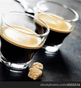 Cups of Espresso on dark rustic background