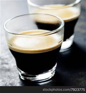 Cups of Espresso on dark rustic background