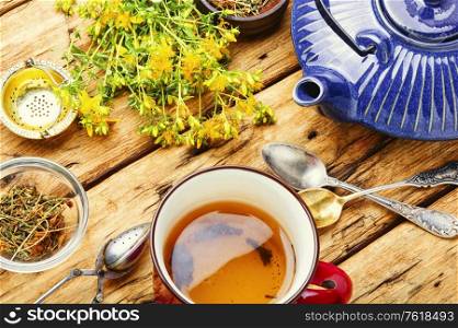 Cups of healthy herbal tea with hypericum.Medicinal herb. Herbal tea with hypericum