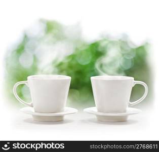 Cups of hot drink on defocus summer background