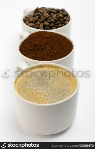 cups with coffee, beans and blend. closeup