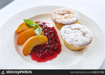 Curd cake with cranberry sauce and peach. Curd cake with cranberry