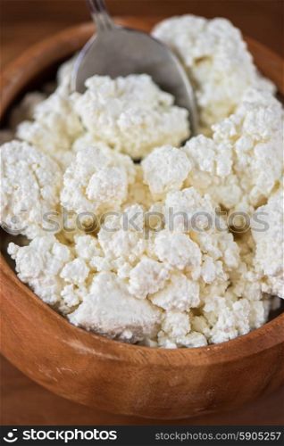 curd in a bowl. curd in brown wooden bowl closeup