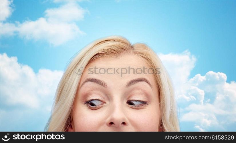 curiosity, advertisement and people concept - happy young woman or teenage girl face over blue sky and clouds background