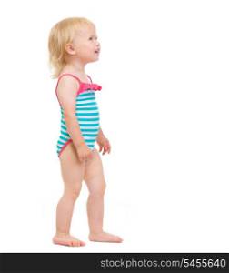 Curious baby in swimsuit looking on copy space