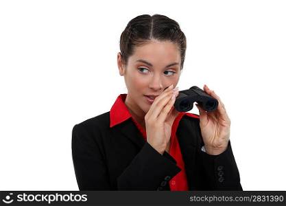 Curious brunette holding binoculars
