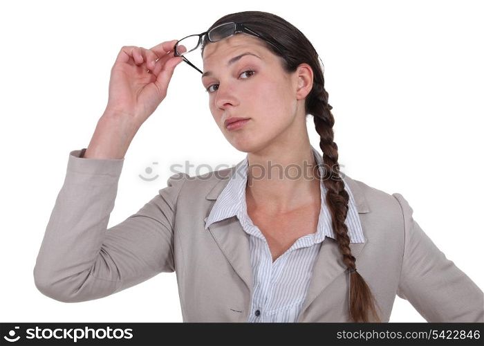 Curious businesswoman lifting glasses