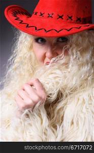 Curly blonde in a red hat and white fluffy fur coat