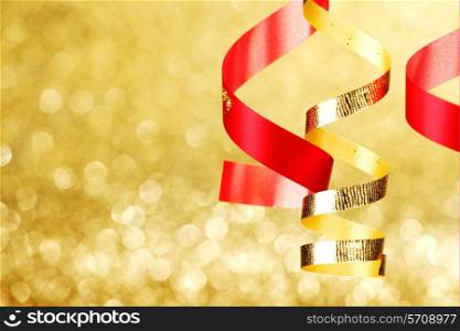 Curly gift ribbons on shiny background close-up