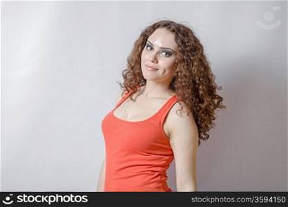 curly hair brunette on white background weared orange red shirt positive girl joy happyness concept