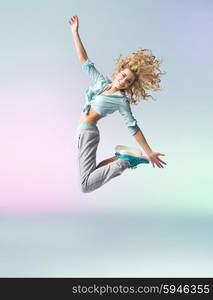 Curly-haired athlete woman dancing and jumping