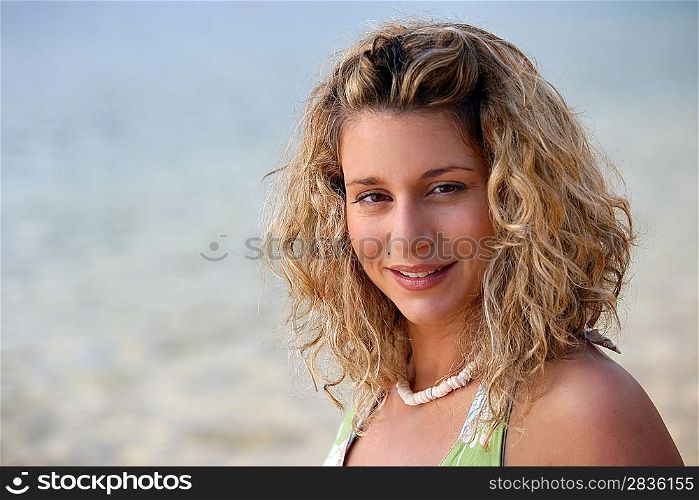 Curly-haired blond woman at the beach