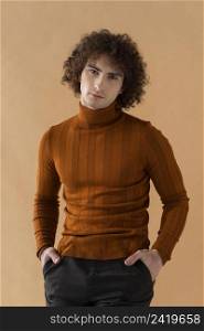 curly haired man with brown blouse posing 3