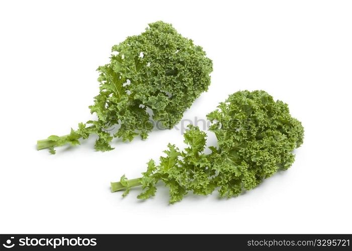 Curly kale leaves on white background