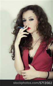 curly long-haired brunette woman with blue cigarette