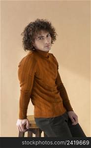 curly man with brown blouse posing 2
