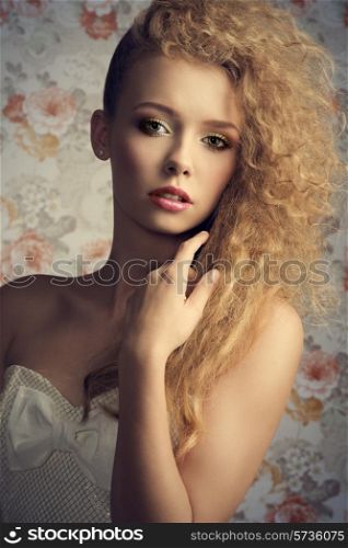 curly pretty girl with blonde stylish hair-style and natural make-up posing in close-up fashion portrait and wearing white lovely dress