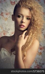 curly pretty girl with blonde stylish hair-style and natural make-up posing in close-up fashion portrait and wearing white lovely dress