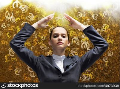 Currency concept. Young businesswoman protecting head from falling symbols