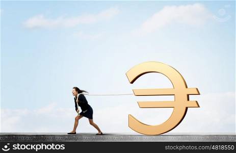 Currency concept. Young businesswoman pulling euro sign with rope