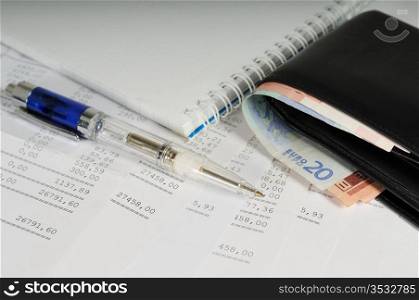 Currency in wallet and pen on banking report stock photo