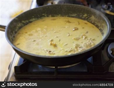 Curry chicken in pan, close up, horizontal image