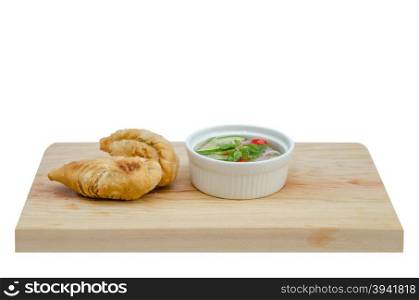 Curry puff pastry . Curry puff pastry with sweet sauce on wooden plate