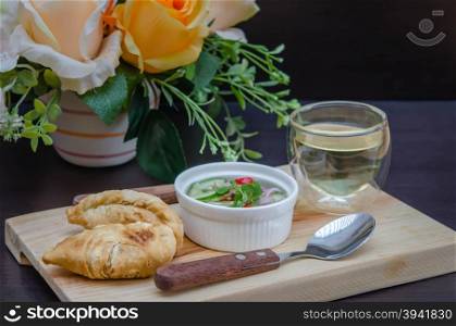 Curry puff pastry . Curry puff pastry with sweet sauce on wooden plate