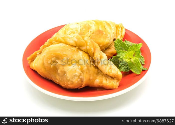 Curry Puffs in a red plate on white background