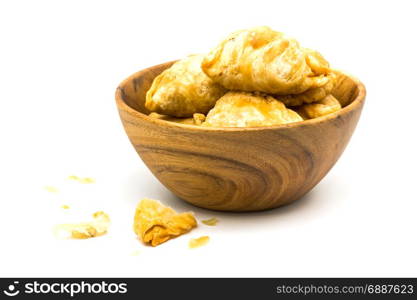 Curry Puffs in a wooden bowl on white background